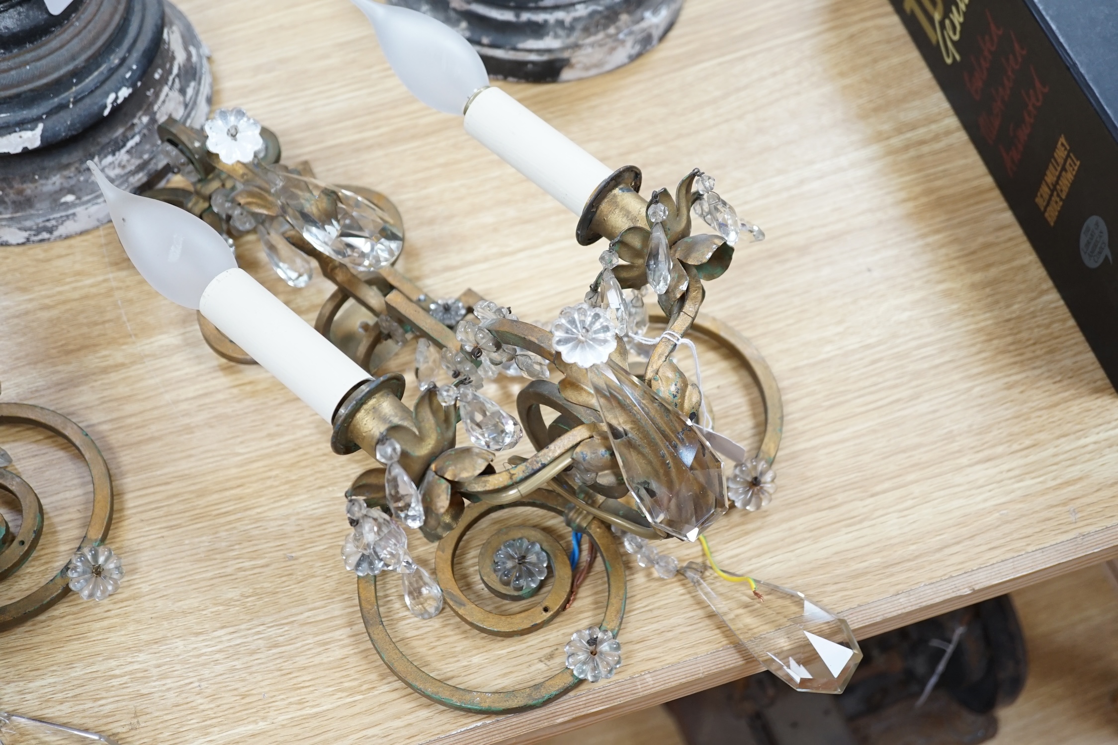 A pair of two branch gilt painted metal wall lights with lustre drops, approximately 44cm high. Condition - fair to good